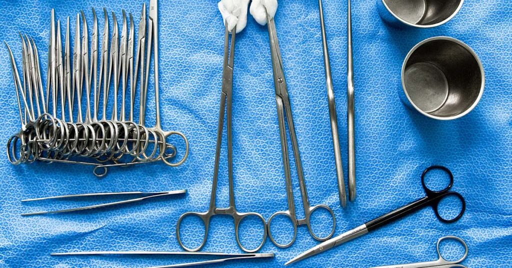 Overhead view of scissors, gauze and stainless steel prepped for a procedure