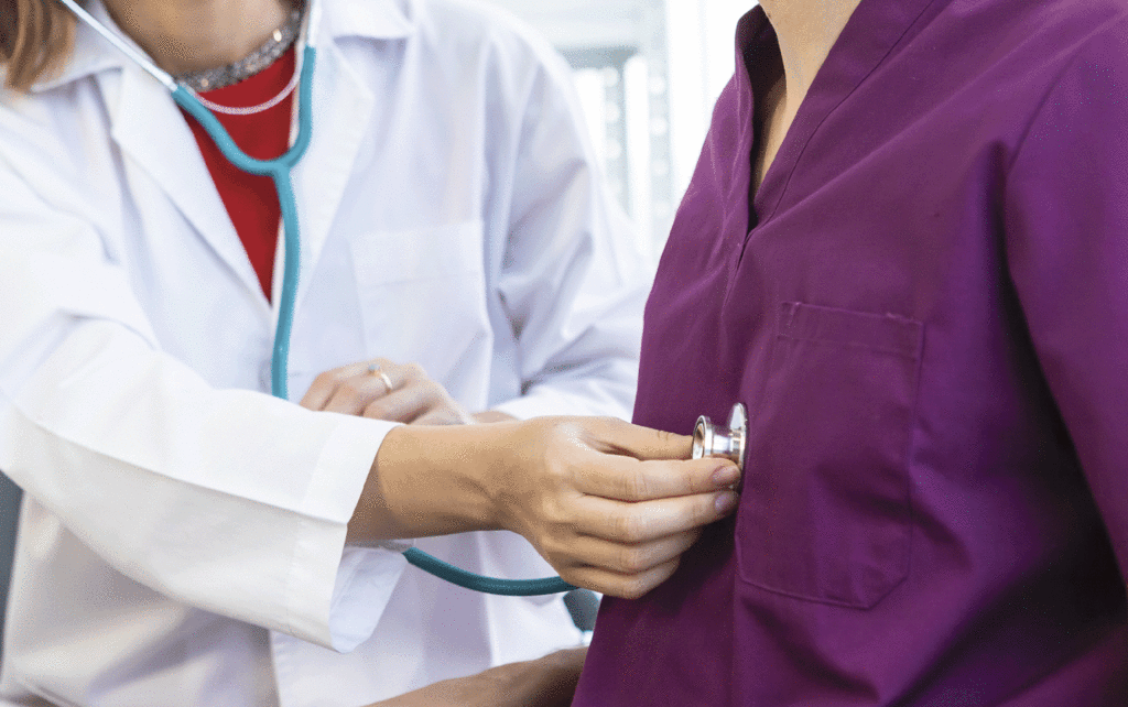 Dr. listening to someone's heart with a stethoscope